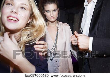 Stock Image - Friends out at night having fun. Fotosearch