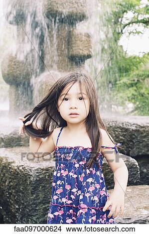 Picture - Little girl by water fountain, portrait. Fotosearch