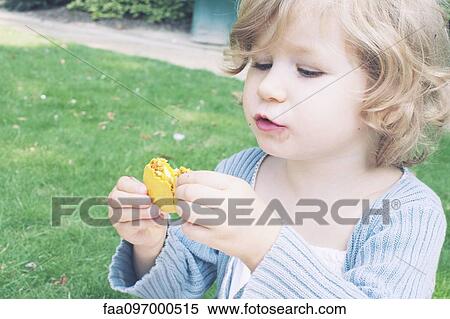 Little girl eating macaroon View Large Photo Image Stock Photography - Little girl eating macaroon. Fotosearch