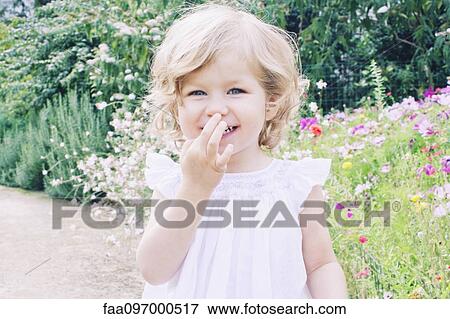 Stock Photo - Little girl on nature path, portrait. Fotosearch