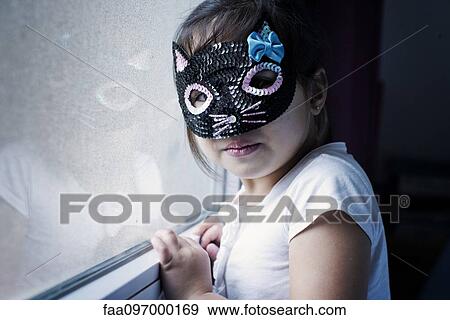 Stock Photo - Little girl wearing mask. Fotosearch