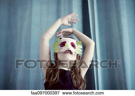 Stock Photo - Llittle girl wearing mask. Fotosearch