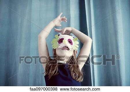Stock Photo - Llittle girl wearing mask. Fotosearch