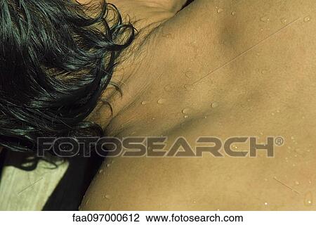 Stock Image - Man sunbathing, extreme close-up. Fotosearch