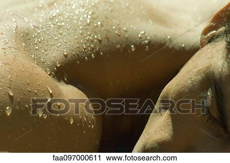 Man sunbathing, water droplets on shoulder, extreme close-up View Large Photo Image Stock Image - Man sunbathing, water droplets on shoulder, extreme close-up. Fotosearch