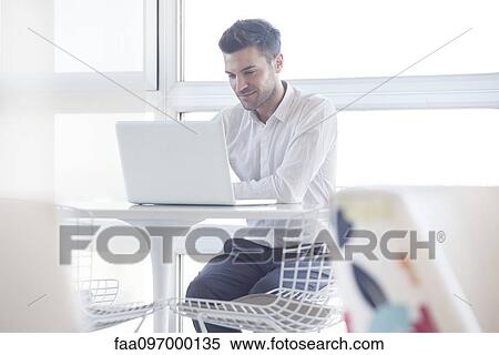 Man using laptop computer in cafe View Large Photo Image Stock Photography - Man using laptop computer in cafe. Fotosearch