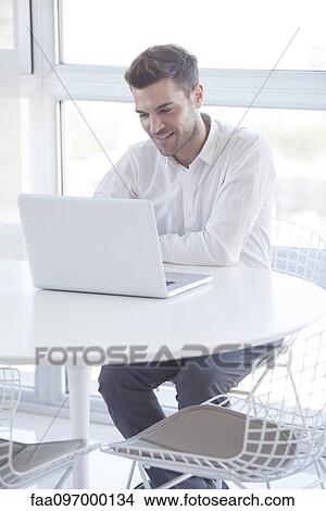 Picture - Man using laptop computer. Fotosearch