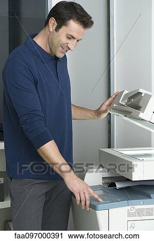 Man using photocopier View Large Photo Image Stock Image - Man using photocopier. Fotosearch