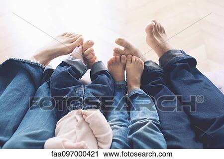 Outstretched legs and barefeet of family with two children View Large Photo Image Stock Image - Outstretched legs and barefeet of family with two children. Fotosearch
