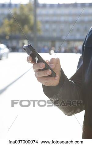 Person using smartphone View Large Photo Image Picture - Person using smartphone. Fotosearch
