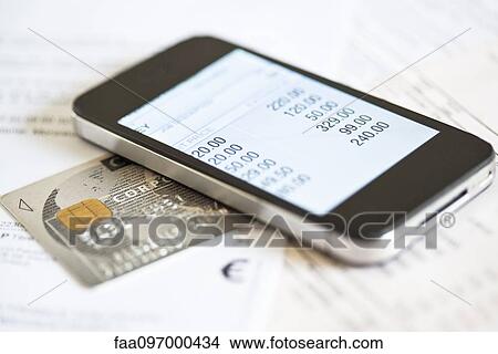Picture - Smartphone being used for online banking. Fotosearch