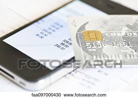 Stock Image - Smartphone being used for online banking. Fotosearch