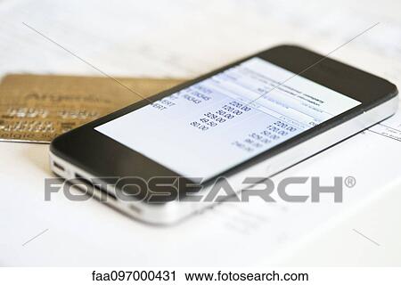 Stock Image - Smartphone being used for online banking. Fotosearch