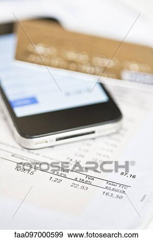 Stock Photo - Smartphone being used for online banking. Fotosearch