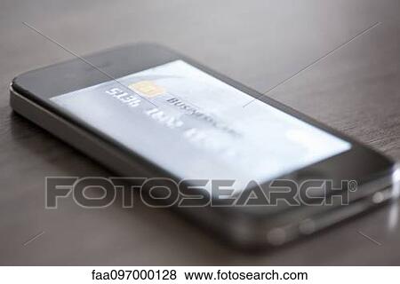 Smartphone displaying image of credit card View Large Photo Image Stock Photo - Smartphone displaying image of credit card. Fotosearch
