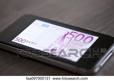 Stock Image - Smartphone displaying image of five-hundred euro banknote. Fotosearch