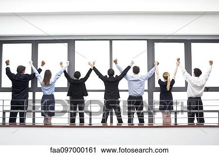 Team of business professionals exhibiting spirit of camaraderie, rear view View Large Photo Image Stock Image - Team of business professionals exhibiting spirit of camaraderie, rear view. Fotosearch