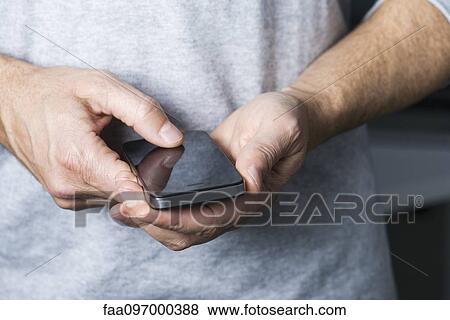 Stock Photo - Using multimedia smartphone, close-up. Fotosearch