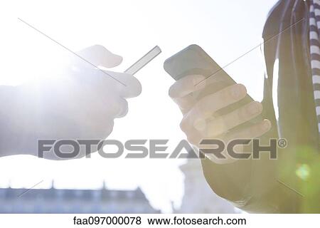 Wirelessly sharing data between smartphones View Large Photo Image Stock Photo - Wirelessly sharing data between smartphones. Fotosearch