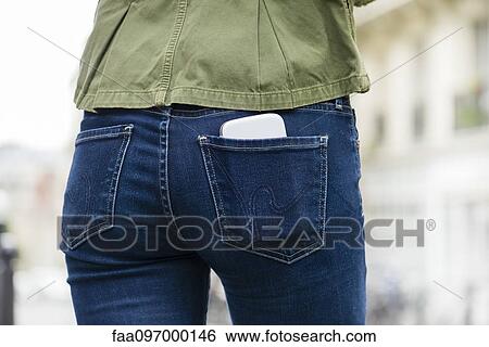 Stock Photograph - Woman carrying smartphone in back pocket. Fotosearch