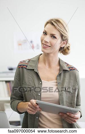 Woman holding digital tablet View Large Photo Image Picture - Woman holding digital tablet. Fotosearch