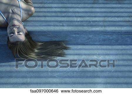 Stock Photograph - Woman lying in shade. Fotosearch