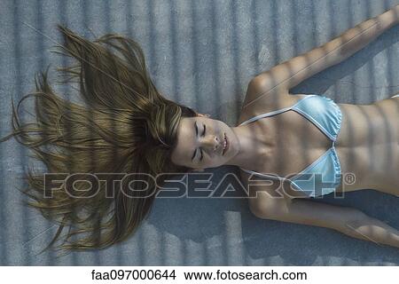 Woman lying on ground in shade View Large Photo Image Picture - Woman lying on ground in shade. Fotosearch