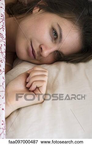 Woman relaxing in bed, cropped View Large Photo Image Stock Photo - Woman relaxing in bed, cropped. Fotosearch