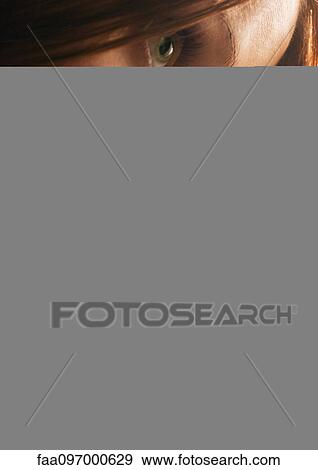 Stock Photo - Woman touching hair, close-up. Fotosearch
