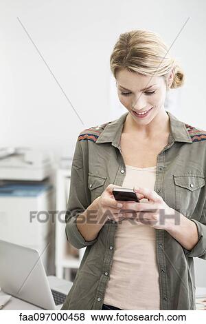 Stock Photo - Woman using cell phone. Fotosearch