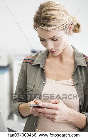 Woman using cell phone View Large Photo Image Stock Photograph - Woman using cell phone. Fotosearch