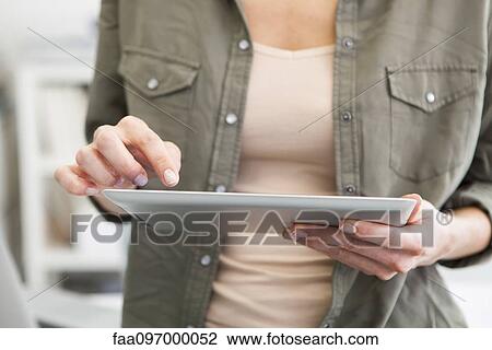 Woman using digital tablet, cropped View Large Photo Image Stock Image - Woman using digital tablet, cropped. Fotosearch