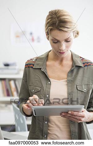 Woman using digital tablet View Large Photo Image Stock Image - Woman using digital tablet. Fotosearch
