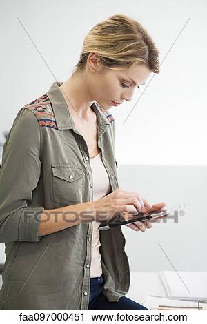 Stock Image - Woman using digital tablet. Fotosearch