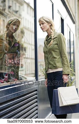 Stock Image - Woman window shopping. Fotosearch