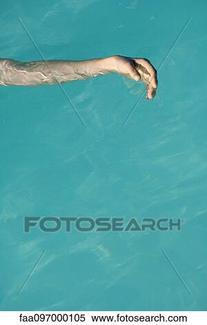 Stock Photography - Woman's arm floating in pool. Fotosearch