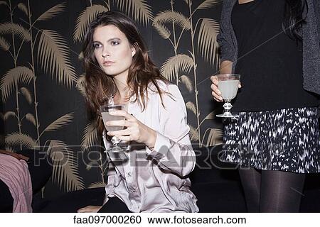 Stock Image - Women in club with cocktails. Fotosearch