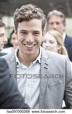 Young business associate with colleagues View Large Photo Image Stock Photo - Young business associate with colleagues. Fotosearch