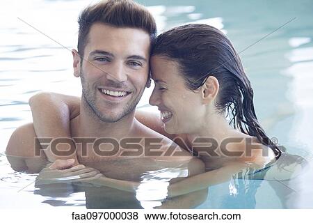 Young couple in pool together, portrait View Large Photo Image Stock Photo - Young couple in pool together, portrait. Fotosearch