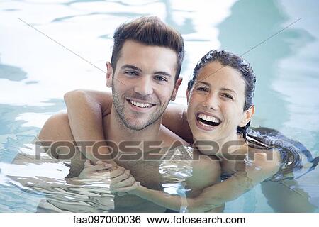 Young couple in pool together, portrait View Large Photo Image Stock Photograph - Young couple in pool together, portrait. Fotosearch