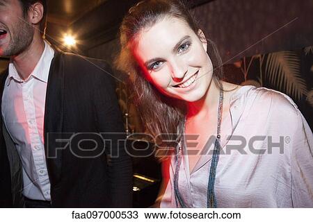 Stock Image - Young woman enjoying the night life. Fotosearch