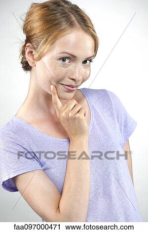 Young woman feigning shyness View Large Photo Image Stock Image - Young woman feigning shyness. Fotosearch