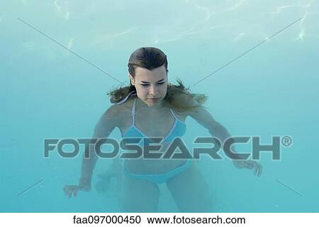 Stock Image - Young woman in swimming pool. Fotosearch