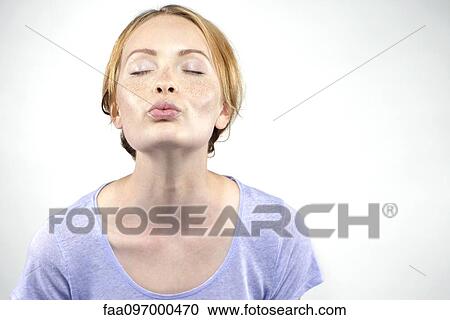 Young woman pursing lips View Large Photo Image Stock Image - Young woman pursing lips. Fotosearch