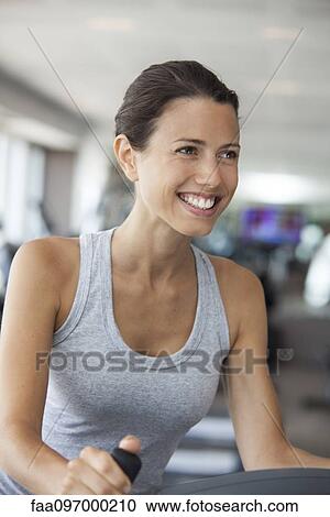 Young woman using step climber at gym View Large Photo Image Stock Image - Young woman using step climber at gym. Fotosearch