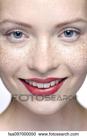 Stock Image - Young woman wearing red lipstick, close-up. Fotosearch