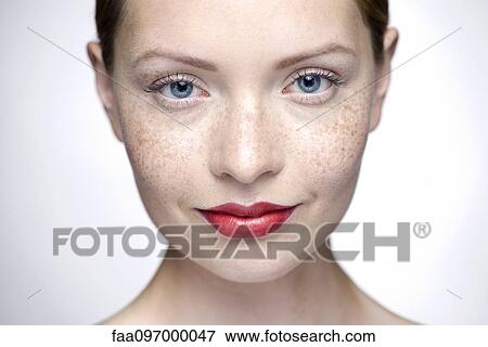 Stock Photo - Young woman wearing red lipstick, close-up. Fotosearch