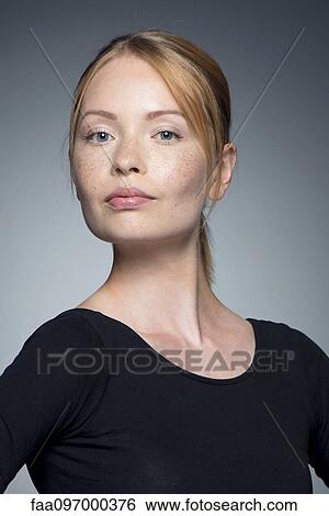 Stock Photograph - Young woman with hands on hips, portrait. Fotosearch