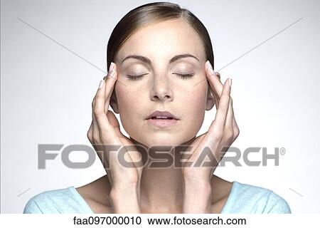 Young woman with headache holding head View Large Photo Image Stock Image - Young woman with headache holding head. Fotosearch