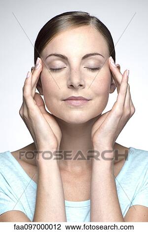 Young woman with headache holding head View Large Photo Image Stock Image - Young woman with headache holding head. Fotosearch